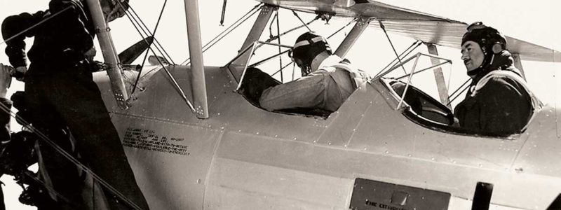 Photo of biplane with pilot and crew