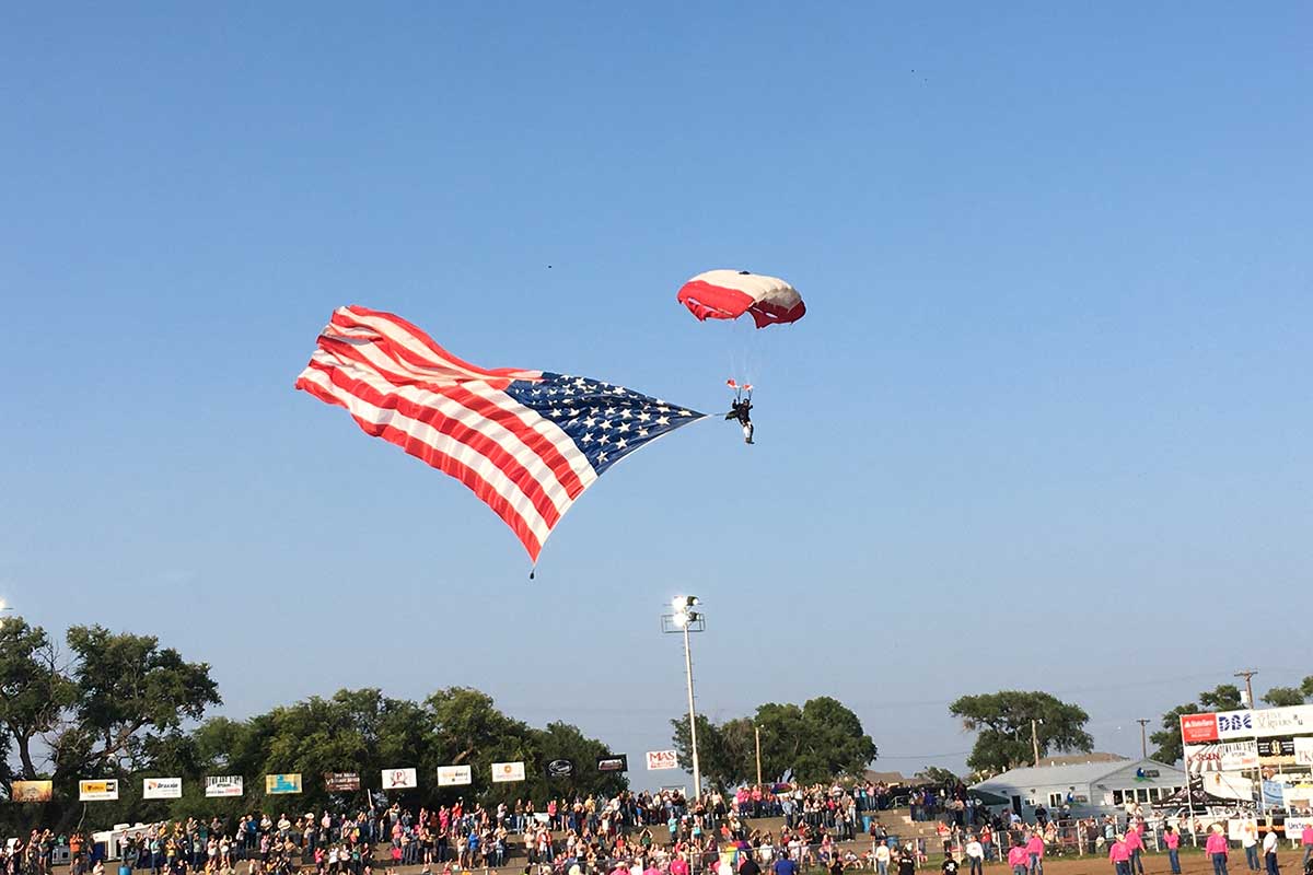 photo of skydiver landing with large American flag