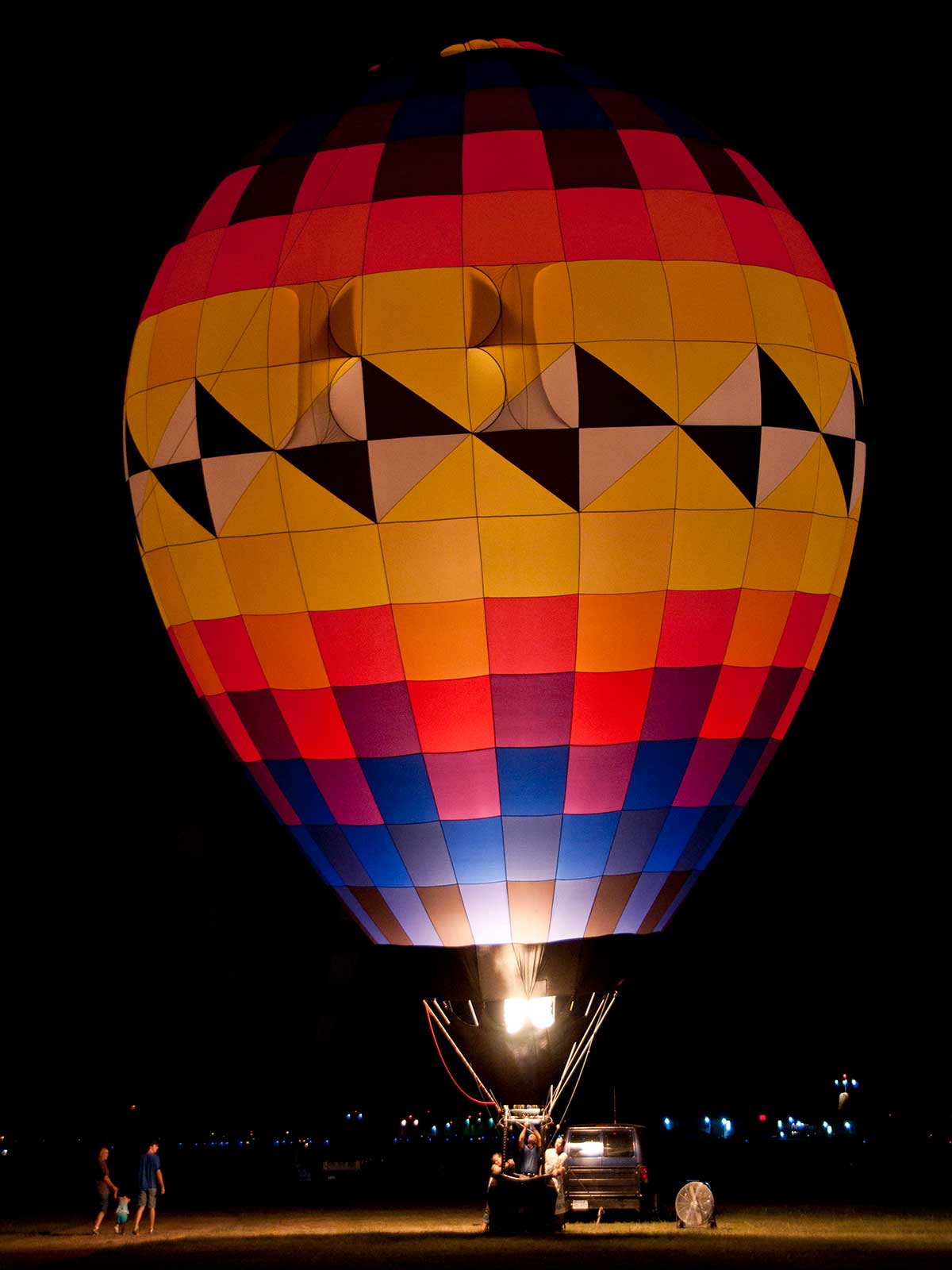 night photo of balloon lit up with burner
