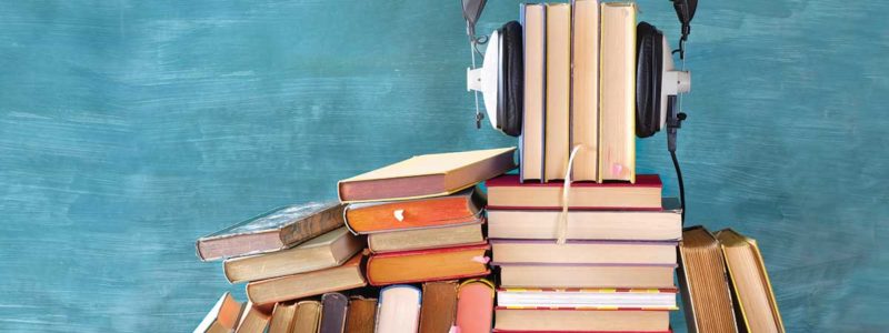 Stack of books with headphones