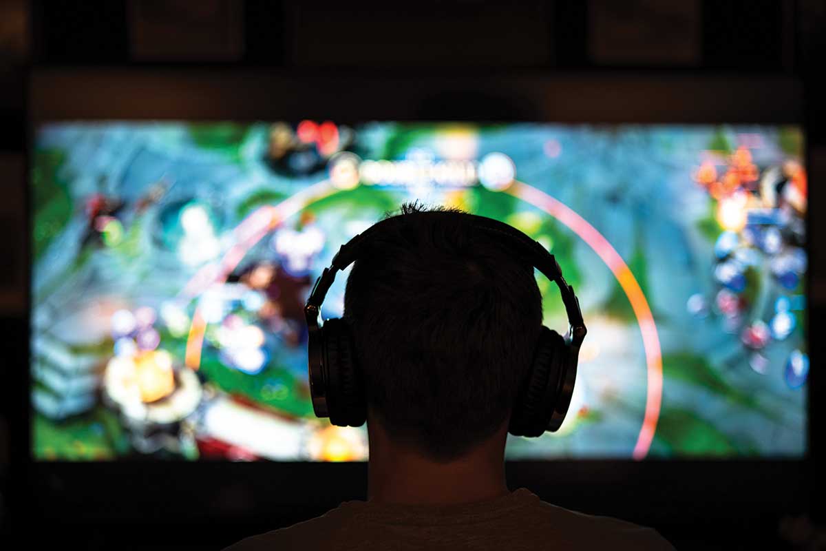 player with headset in front of screen