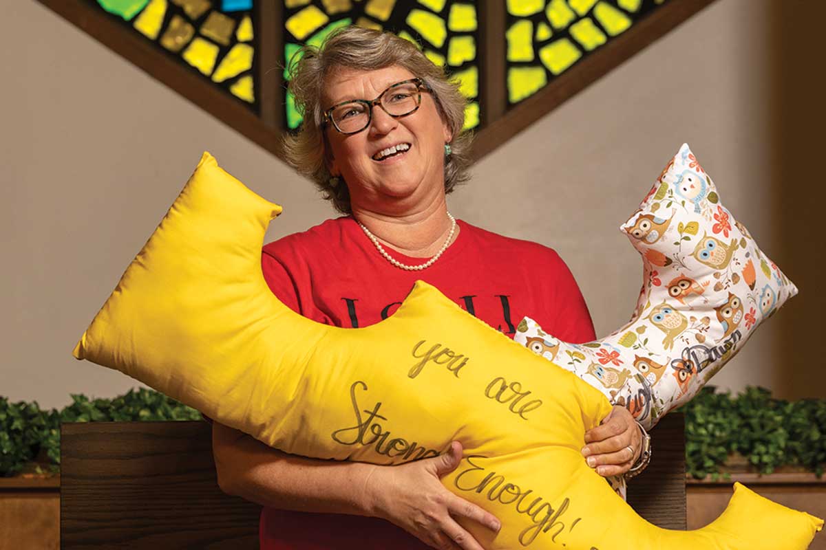 Dawn Compton holds pillows for breast cancer patients