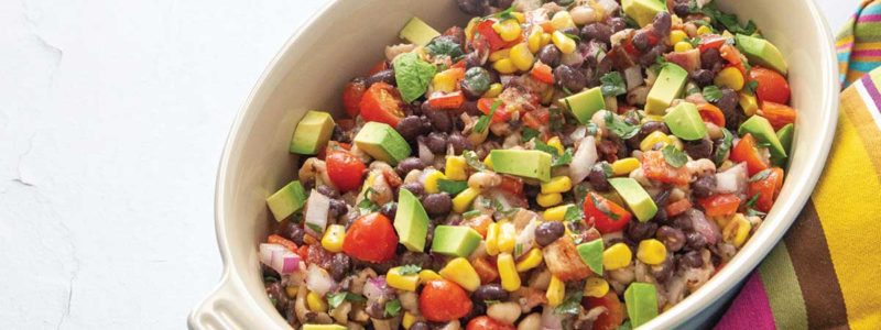 bowl of beans, corn, avocado, bacon, tomato and diced peppers