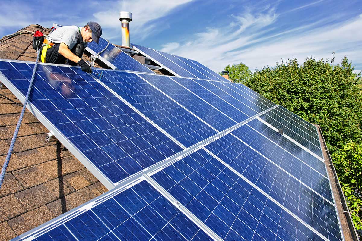 man installing rooftop solar panels