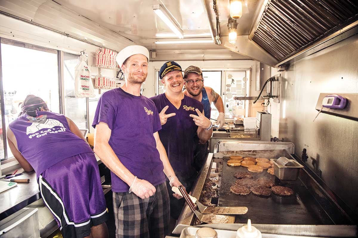 cooks working in burger truck