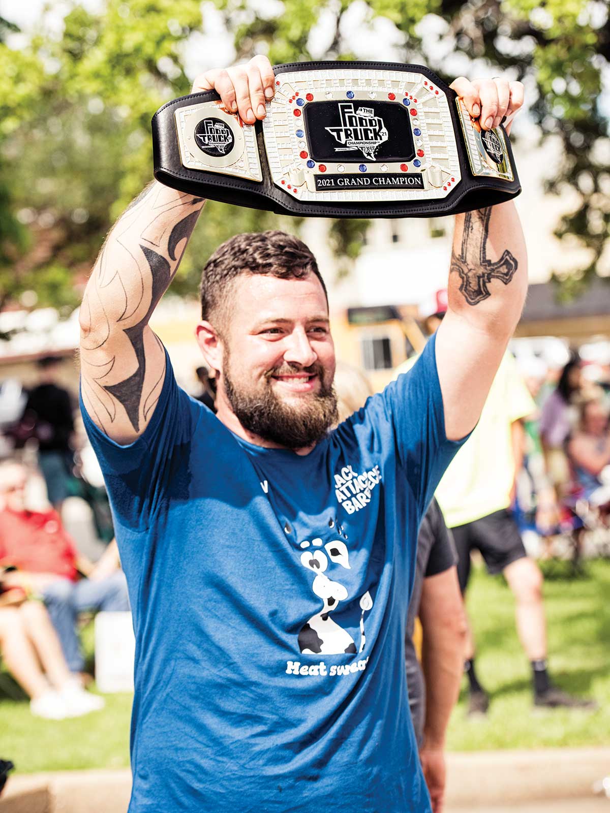 Brandon holds up grand champion belt