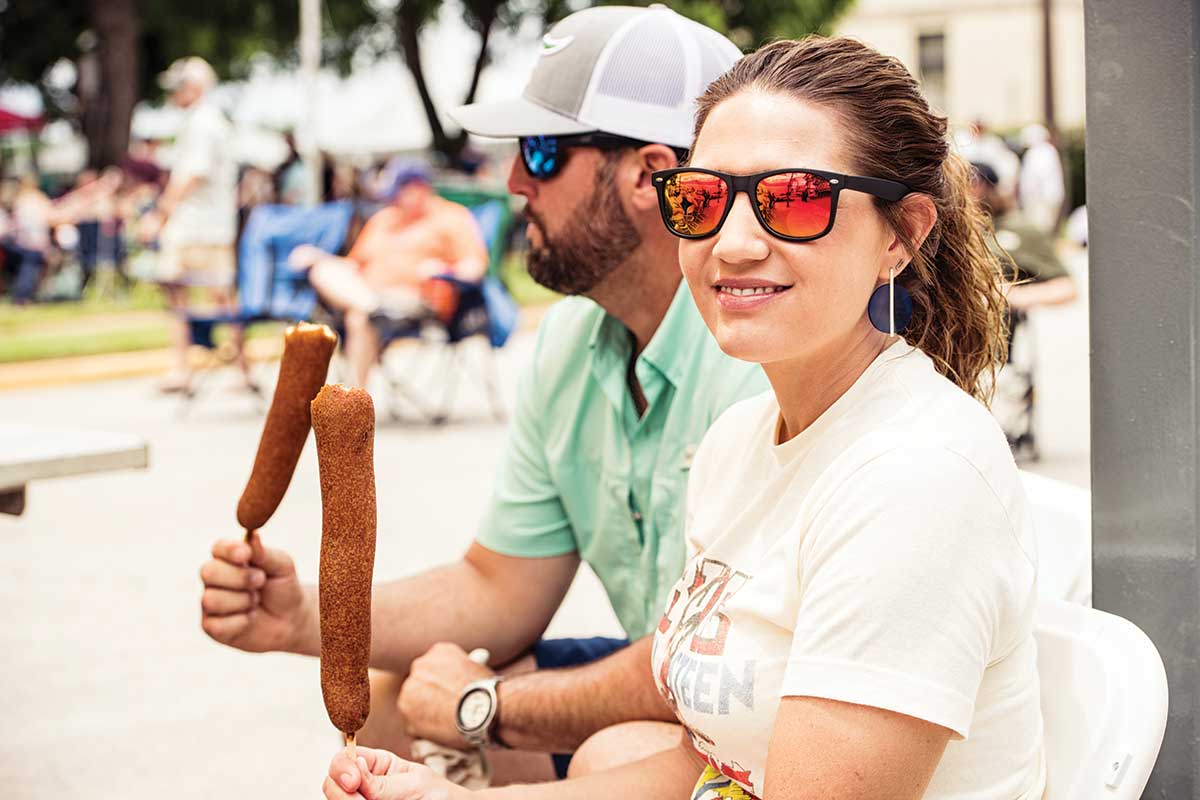 couple eating corn dogs