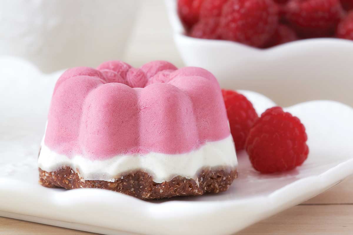 a pink raspberry dessert with an almond crust