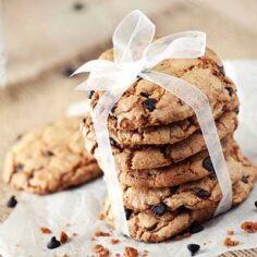 A stack of cookies gift wrapped with a bow