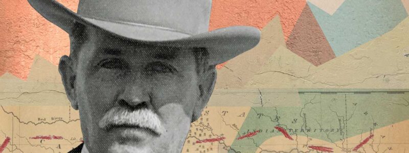 Joe Furey wearing cowboy hat with a map in background