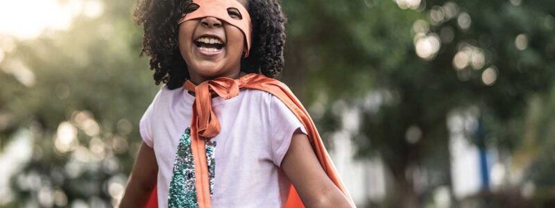 Young girl dressed in superhero costume