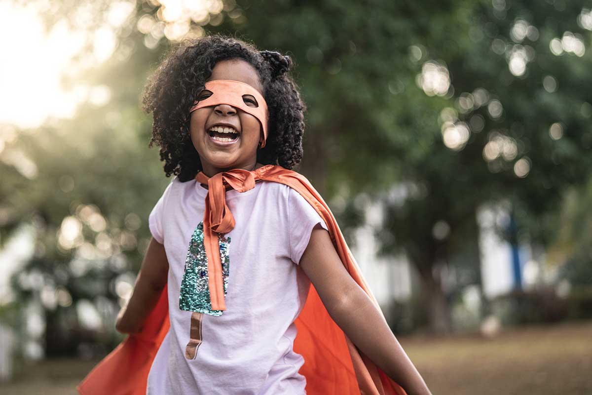 Young girl dressed in superhero costume