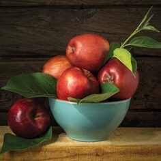 a bowl of apples on a table