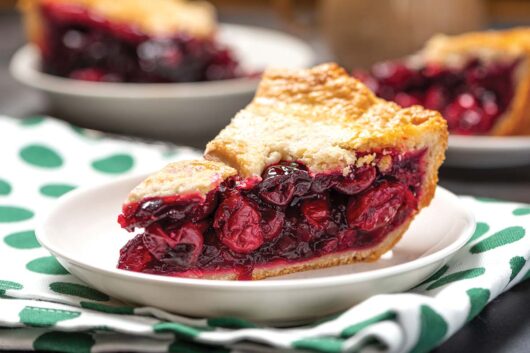 A slice of cherry pie on a plate