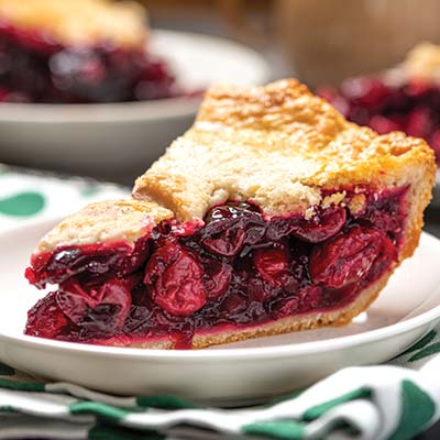 A slice of cherry pie on a plate