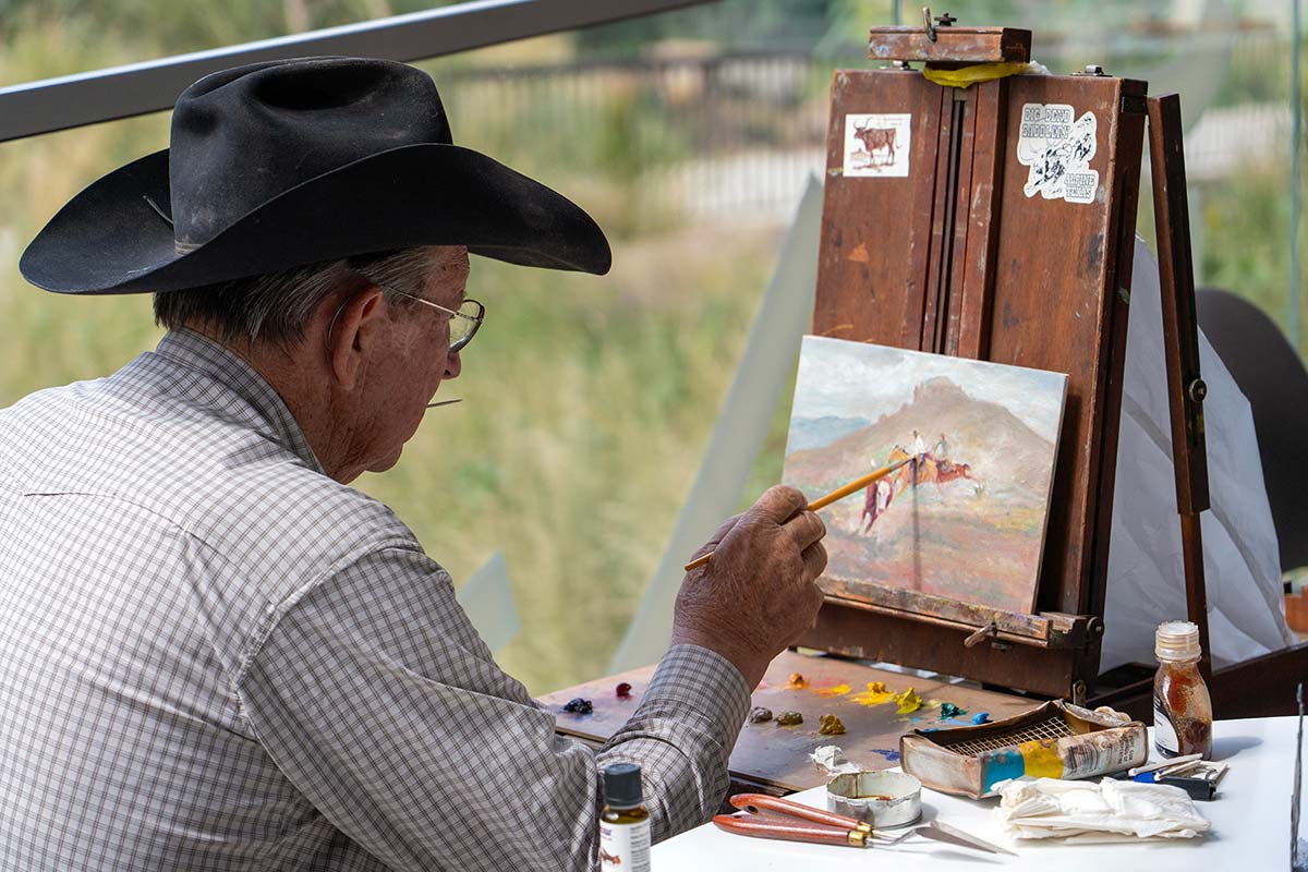 An artist creates a painting outdoors