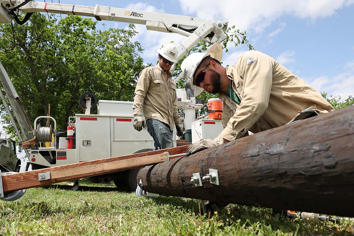 linemen work on a pole